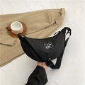 Minimalist black crescent moon crossbody bag in durable nylon with YUN QING logo - Black