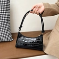 Detail of black crocodile pattern baguette bag with glossy texture and slim handle - 627 Black