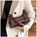 Detail view of dark brown croc-effect patent leather handbag styled with cream blazer - 627 Brown