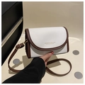 Detail view of contrast stitch shoulder bag with white pebble texture and brown trim - White