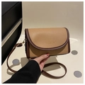 Detail view of the pebbled leather texture and gold lettering on this crossbody bag - Khaki