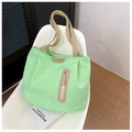 Minimalist mint green canvas tote bag with fashion tag on a white chair - Light Green