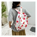 Detail of white backpack with strawberry and daisy prints on adjustable straps and pockets - White