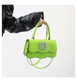 Detail of green wave edge handbag featuring a crystal buckle and glossy PU leather - Fluorescent Green