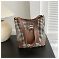 Detail of houndstooth tote bag with brown leather trim and horn shaped buckle decor - White