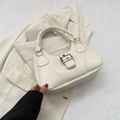 Chic beige textured handbag with silver buckle closure on a stylish suit background - White