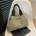 Fuzzy bean green faux fur handbag with black strap on white chair for winter - Green