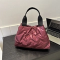 Quilted burgundy padded puffer tote bag with black strap in a minimalist style - Red
