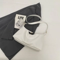 Minimalist white pebbled leather crescent shoulder bag with elegant gold buckle - White