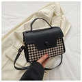 Detail van pied-de-poule stof en zwarte lederen flap met een ronde knoopsluiting - Zwart Houndstooth