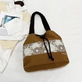 Brown canvas bucket bag with white floral lace trim and adjustable shoulder strap - Tan