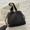 Chic black quilted tote bag with drawstring closure and soft textured fabric finish - Black