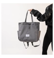 Detail of grey nylon drawstring backpack bag with adjustable straps and side pocket - Gray