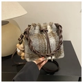 Macro shot of grey plaid wool bucket bag with woven handle and plush bear charm - Gray With Pendant