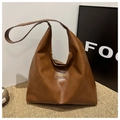 Detail of a brown PU leather hobo bag with Fashion & Bags square embossed label - Tan