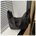 Minimalist large black canvas dumpling bag with adjustable strap and knot zipper detail - Black