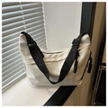 Minimalist white canvas dumpling bag with wide black strap and woven rope zipper detail - White