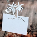 White laser-cut place card with palm tree design for beach themed wedding table decor - White