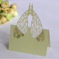 Pale green laser-cut wedding place card featuring symmetrical peacocks and heart shape - Emerald Green