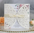 Elegant cream laser-cut wedding invitation with silk bow and pink floral inner card - Ivory