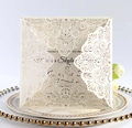 Detail of laser-cut lace floral pattern on off-white wedding invitation card - Ivory