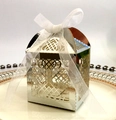 Close-up of laser-cut silver candy box with intricate heart patterns and white bow - Reflective Silver