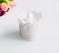 Detail of white laser-cut floral paper sleeve with flickering LED tea light inside - White