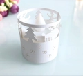 Close-up of white paper candle lampshade featuring hollowed reindeer and tree patterns - White