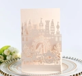 Pink laser-cut wedding invitation featuring a romantic castle and horse carriage design - Nude Pink
