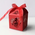 Detail of red laser-cut wedding candy box with bird patterns and silk ribbon bow - Pearlescent Red