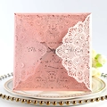 Pink laser-cut lace wedding invitation card with floral hollow pattern in a decorative setting - Pink