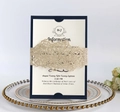 Detail of laser-cut glitter gold belly band on navy blue wedding invitation suite - Gold Rose