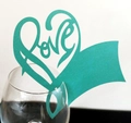 Detail of Tiffany blue hollow heart place card with artistic Love cutout on a glass - Tiffany Blue