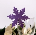 Macro shot of purple glitter snowflake place card laser cut on clear glass rim - Dark Purple