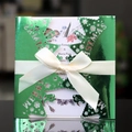 Green laser-cut Christmas invitation set with metallic sleeve and satin ribbon bow - Reflective Green