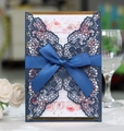 Detail of laser cut lace wedding invitation with navy blue sleeve and ribbon bow - Dark Blue