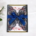 Detail of laser-cut butterfly invitation with royal blue satin ribbon and floral card - Charcoal Black