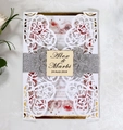 Macro view of laser cut wedding invitation with silver glitter band and floral inner sheet - Gold Rim Rose Hollow Style (HK-88)