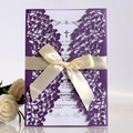 Elegant purple laser-cut wedding invitation featuring a cream ribbon and vine patterns - Deep purple