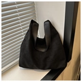 Detail of black matte tote bag with premium leather handles on a natural lit windowsill - Black