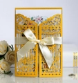 Golden laser-cut wedding invitation with cream ribbon bow and floral inner card - Gold