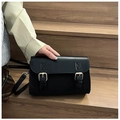 Detailed macro view of the black retro crossbody bag with double gold metallic buckles - Black