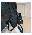 Detail of black crocodile texture tote bag with mini pouch and gold chain accessories - Black