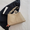 Beige pebble leather tote bag with a wide geometric woven shoulder strap and metal hardware - Khaki