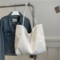 Minimalist white canvas tote bag for women shown hanging as a stylish shoulder bag option - White
