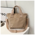Detail of khaki nylon tote bag with silver magnetic clasp and wide woven straps - Khaki