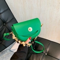 Vibrant green PU leather saddle bag with gold metal lock and decorative floral scarf detail - Green