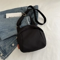 Minimalist black canvas crossbody bag with orange fashion tag and adjustable strap - Black