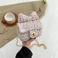 Pink tweed mini crossbody bag with a large bow detail and elegant gold chain strap - Pink