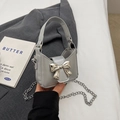 Silver mini bow handbag with metallic chain strap and glossy leather finish - Silver
